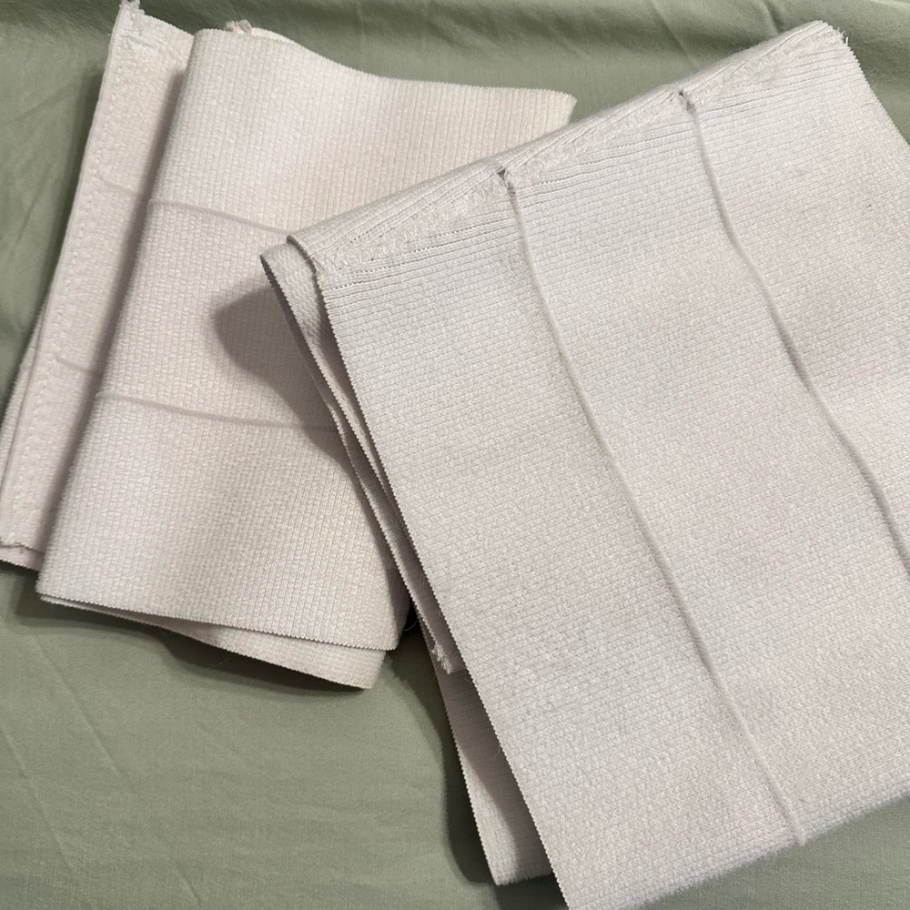 Two white abdominal binders